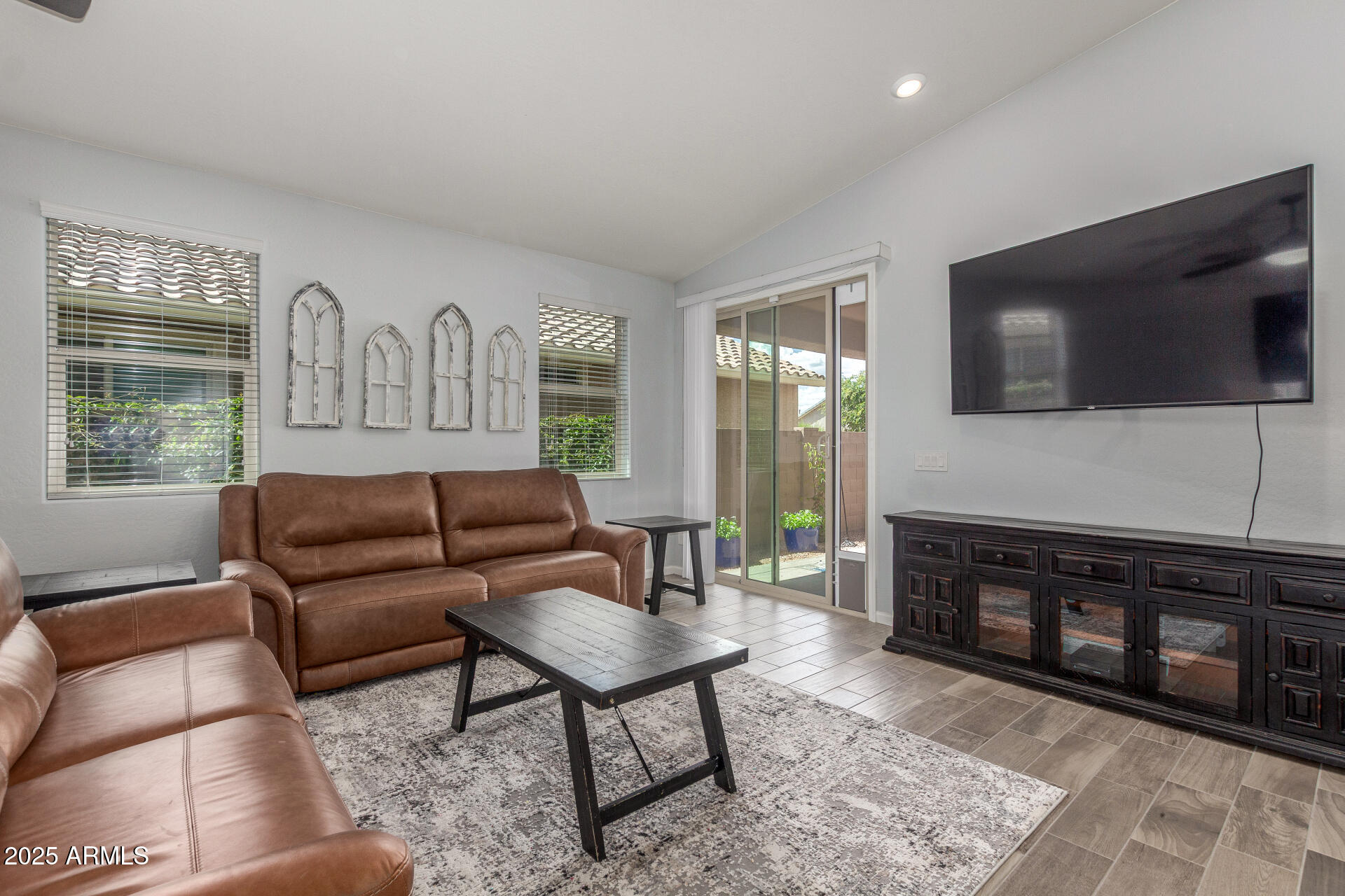 4136 West Palace Station Road New River, AZ 85087 - Photo 4 of 19 a living room with furniture a flat screen tv and a fireplace