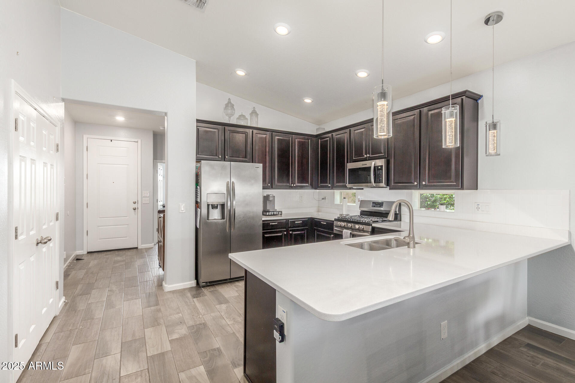 4136 West Palace Station Road New River, AZ 85087 - Photo 5 of 19 a kitchen with stainless steel appliances a sink stove and refrigerator