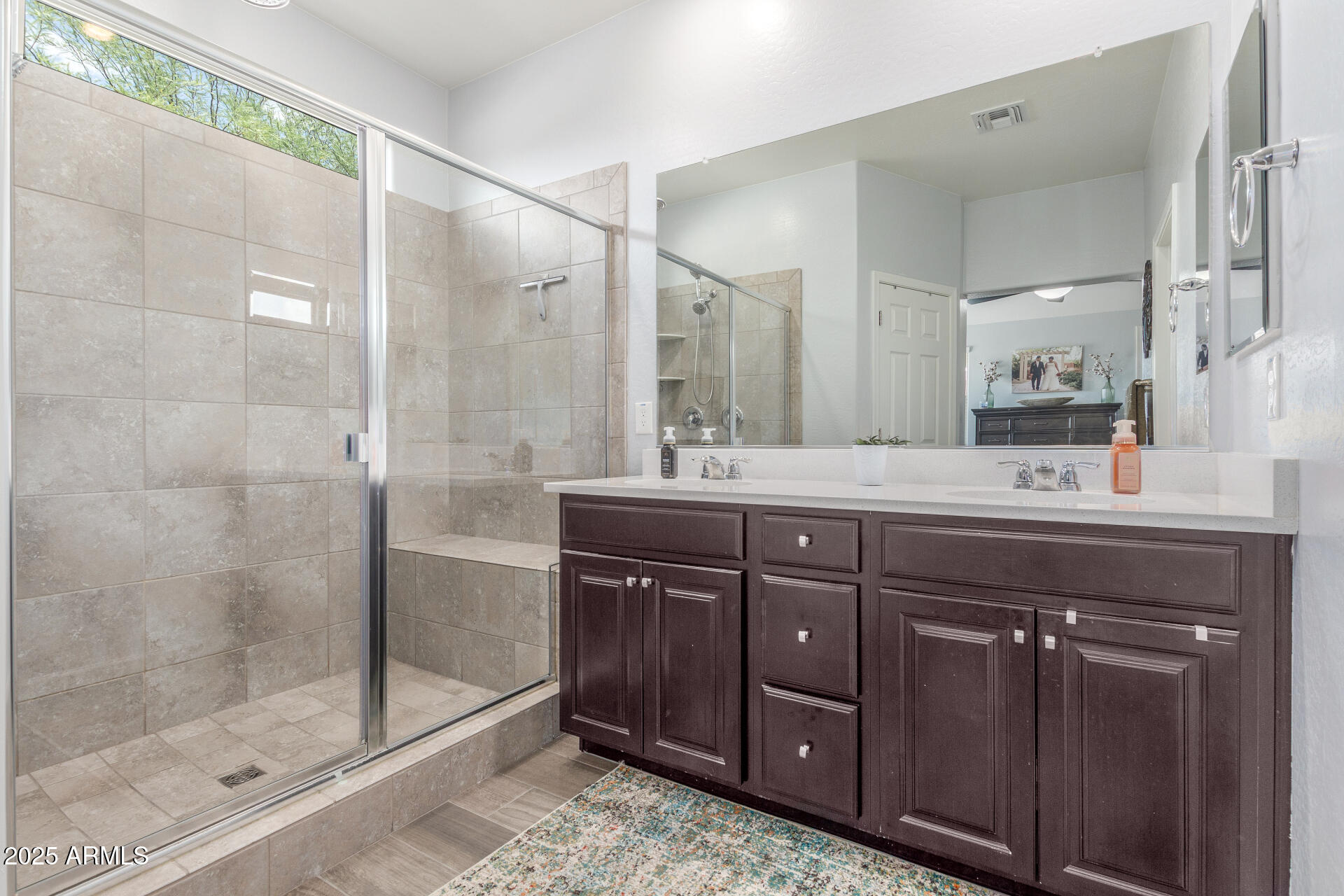 4136 West Palace Station Road New River, AZ 85087 - Photo 8 of 19 a bathroom with a granite countertop sink a mirror and shower