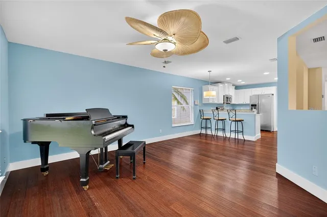 a view of a room with wooden floor and windows