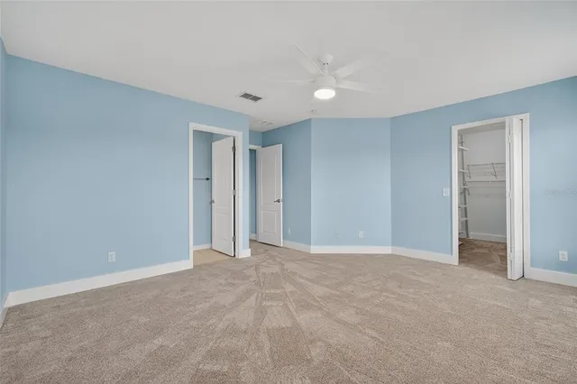 a front view of a house with a yard and tree