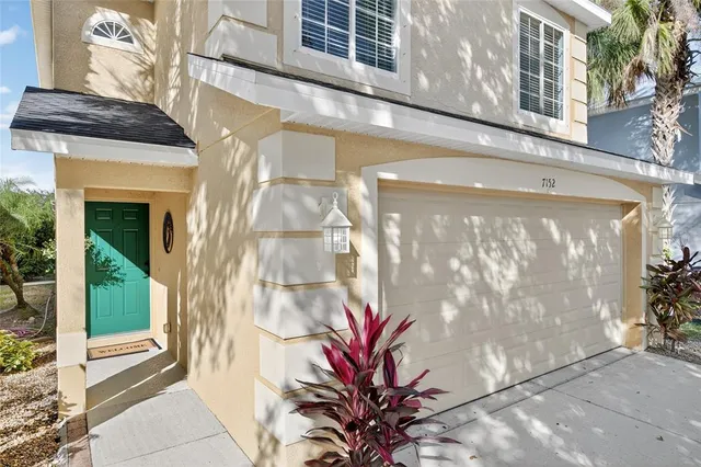 a kitchen with stainless steel appliances granite countertop a refrigerator a stove a sink a microwave and a refrigerator