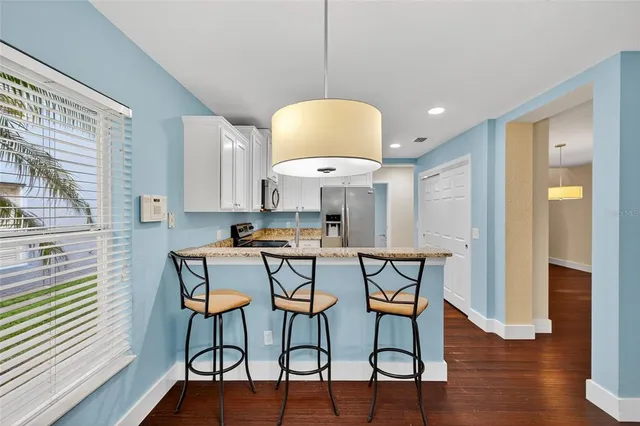 a view of a work space with furniture and wooden floor