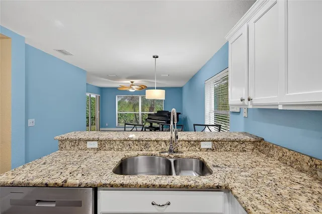 a view of room with wooden floor and chandelier