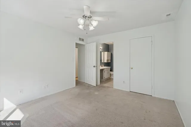 a view of a chandelier and a chandelier fan in a room