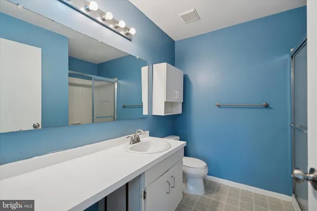 a bathroom with a sink a toilet and mirror