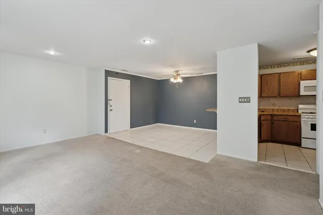 a view of a kitchen with a sink and a refrigerator