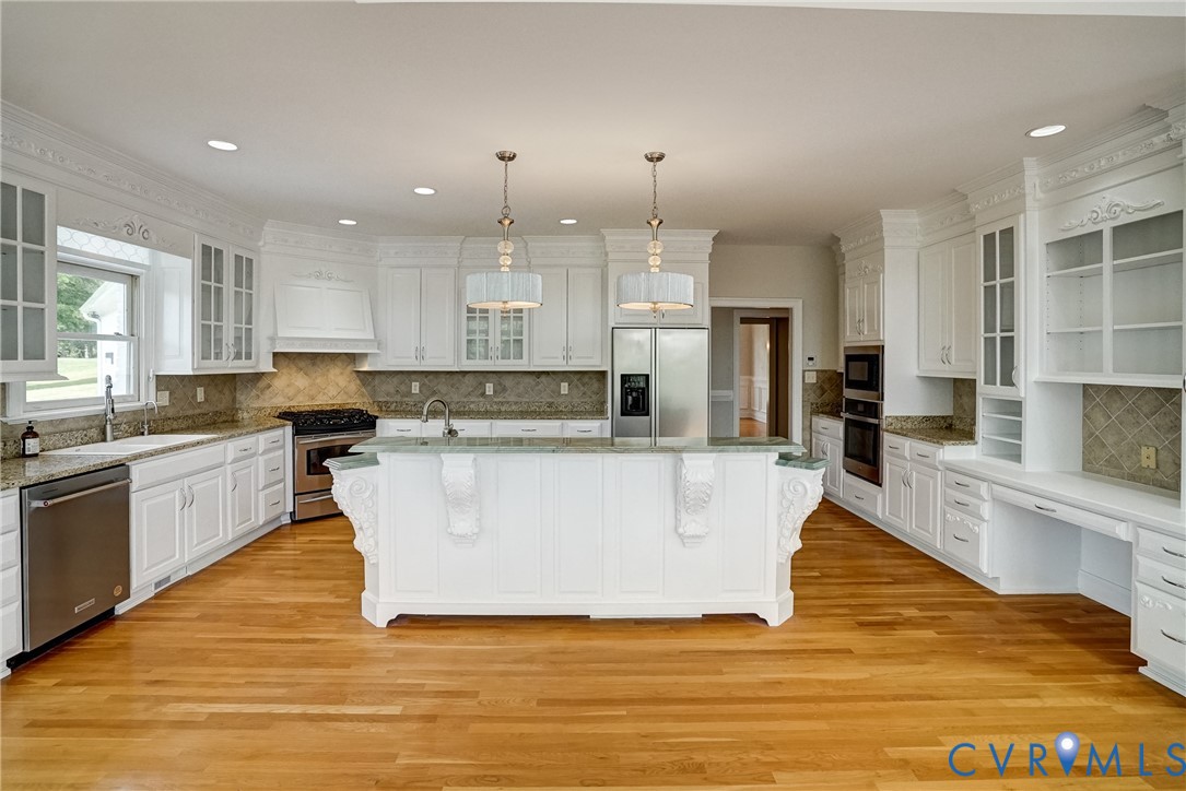 721 Meadow View Ridge Manakin-Sabot, VA 23103 - Photo 16 of 45 a large white kitchen with kitchen island a stove a sink a refrigerator and white cabinets