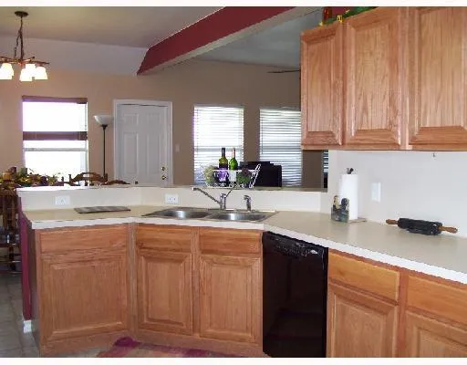 a kitchen with stainless steel appliances granite countertop a sink a stove and cabinets