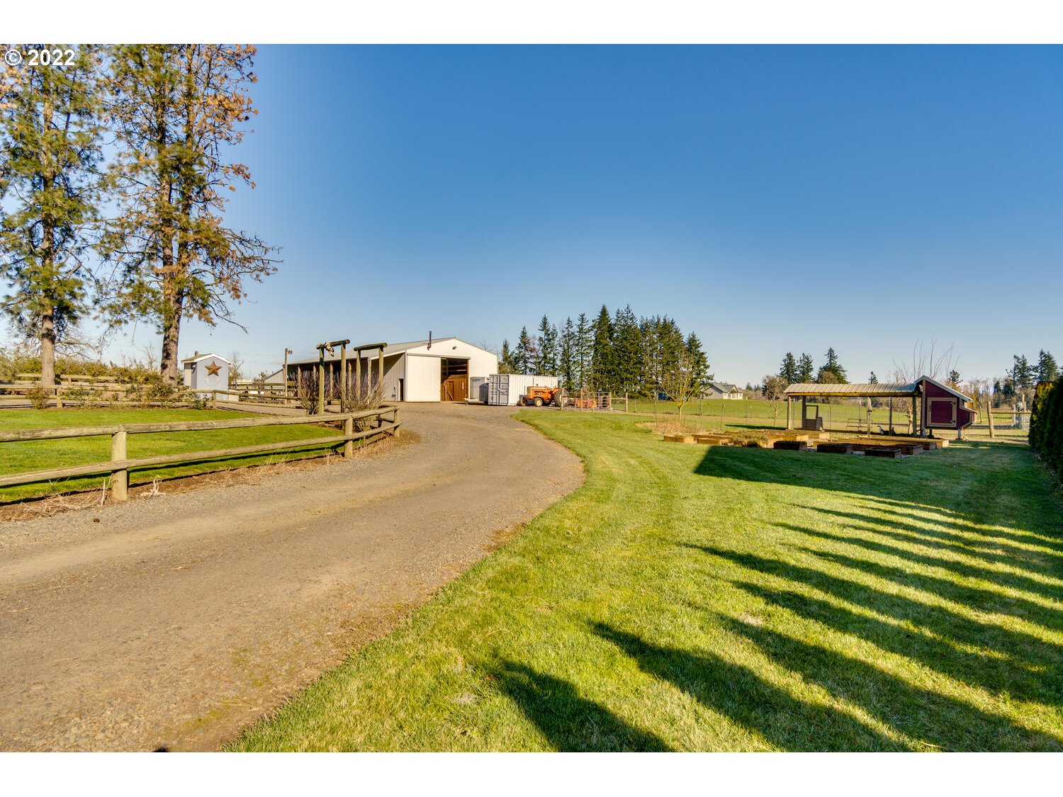 18876 Butteville Road Northeast Aurora, OR 97002 - Photo 21 of 32 a view of a swimming pool with an outdoor seating and a yard
