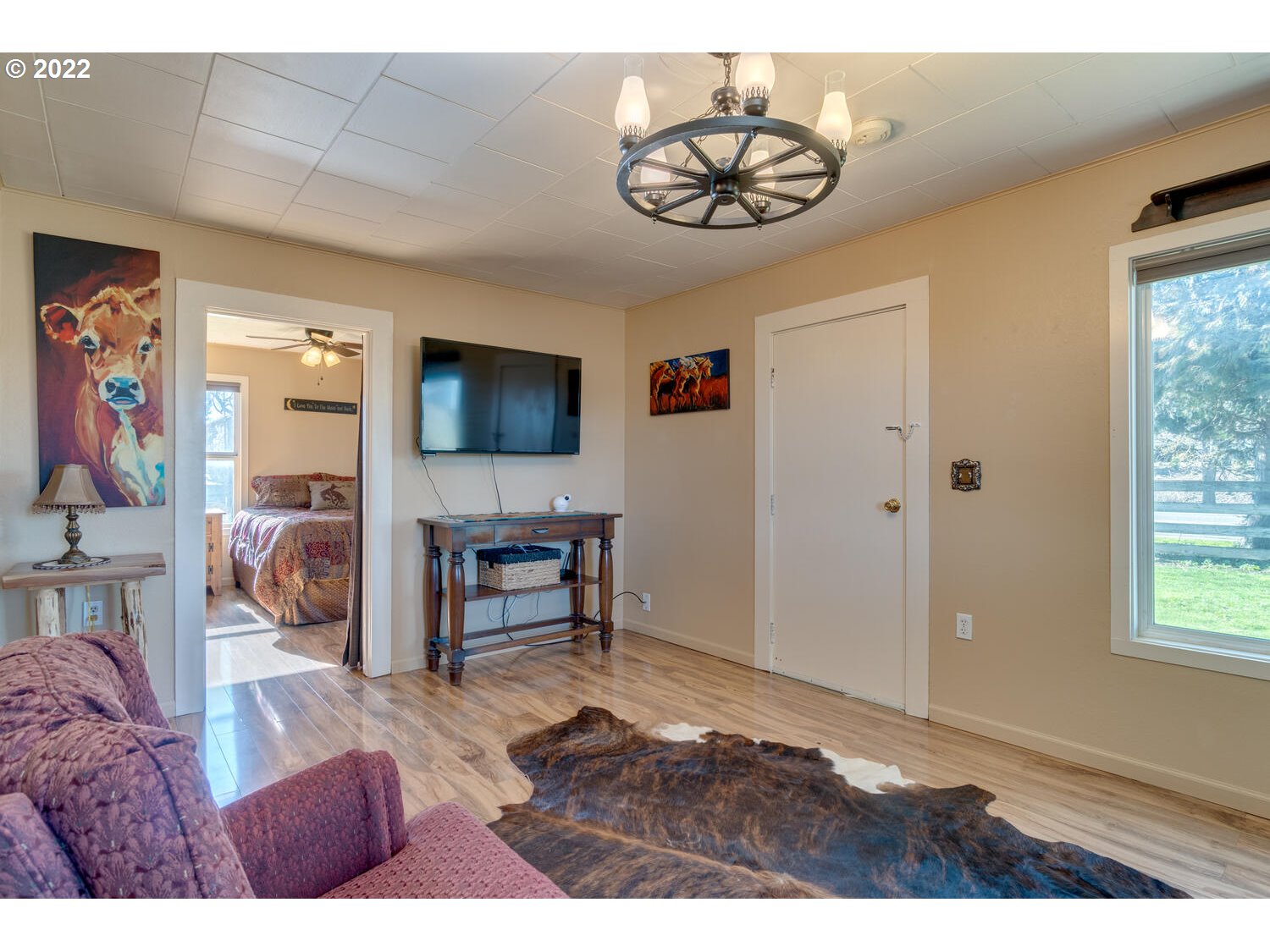 18876 Butteville Road Northeast Aurora, OR 97002 - Photo 3 of 32 a living room with furniture a flat screen tv and a window