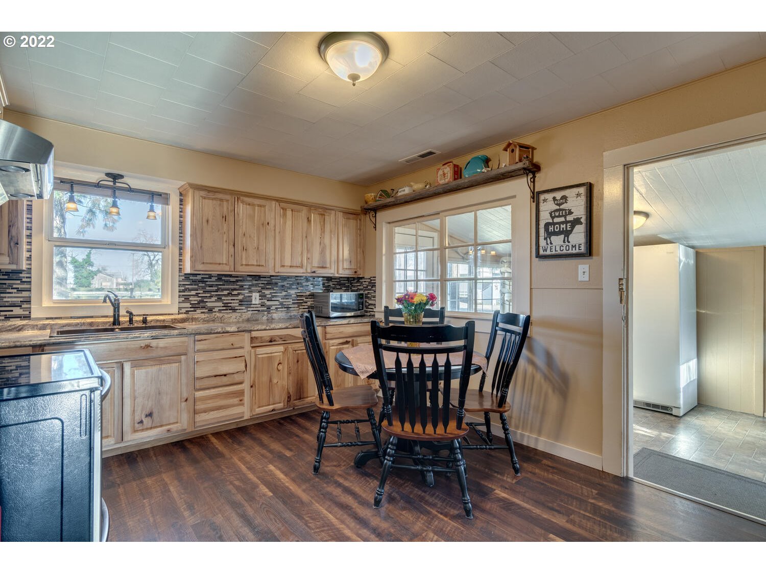 18876 Butteville Road Northeast Aurora, OR 97002 - Photo 5 of 32 a kitchen with a table chairs refrigerator and cabinets