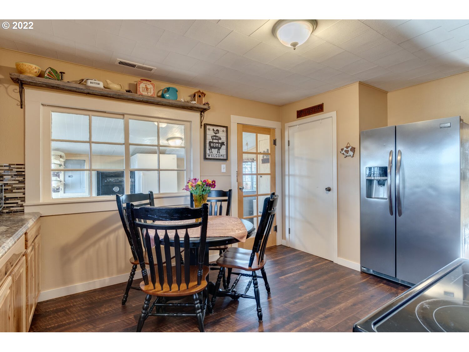 18876 Butteville Road Northeast Aurora, OR 97002 - Photo 6 of 32 a view of a dining room with furniture a chandelier and wooden floor