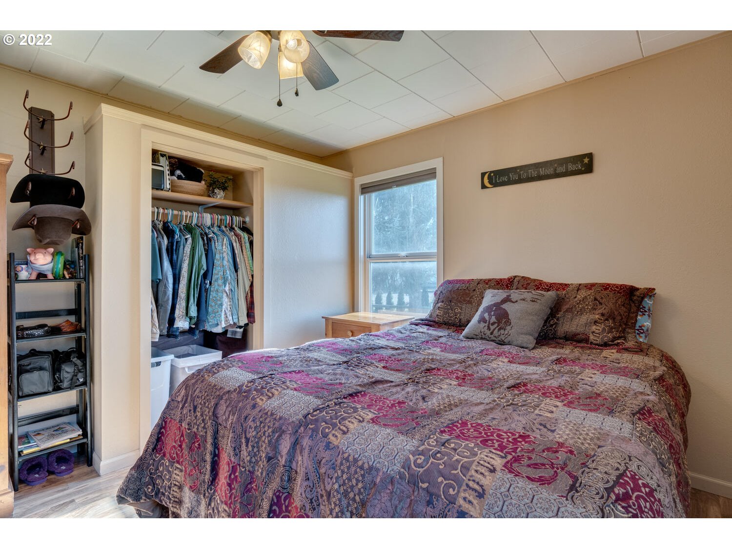 18876 Butteville Road Northeast Aurora, OR 97002 - Photo 8 of 32 a bedroom with a large bed and a chandelier