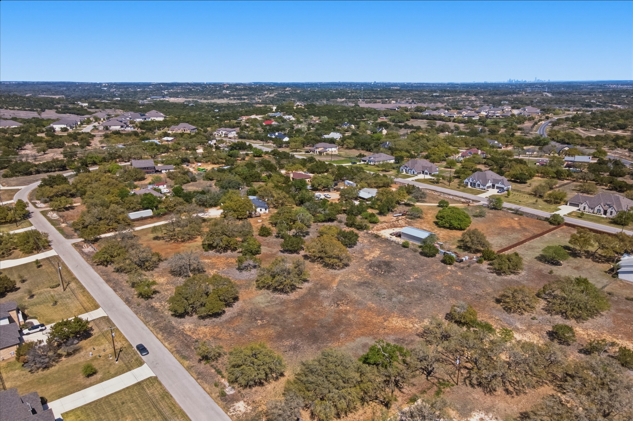 268 Kinnikinik Loop Austin, TX 78737 - Photo 2 of 32 an aerial view of residential houses with outdoor space