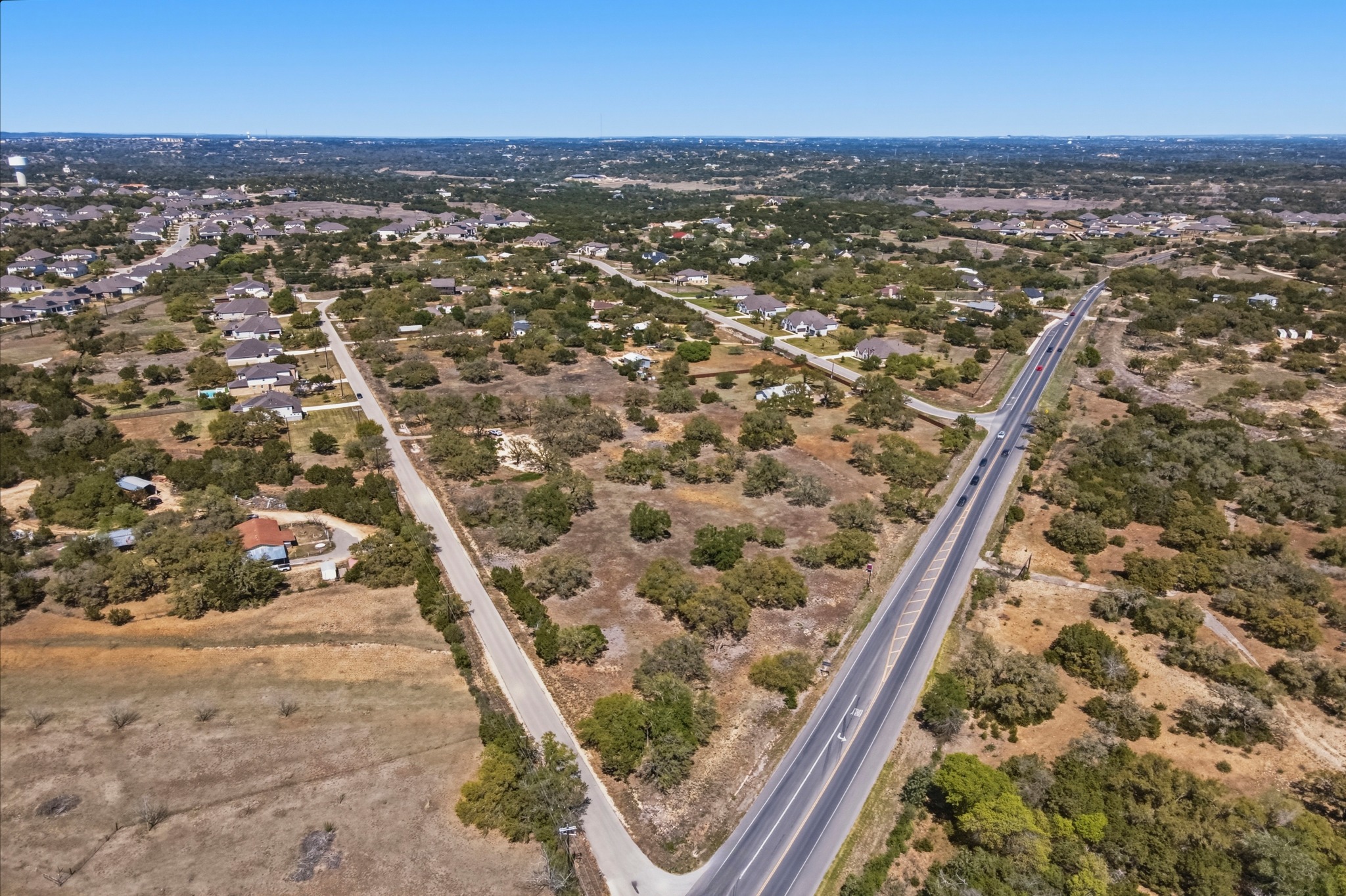 268 Kinnikinik Loop Austin, TX 78737 - Photo 4 of 32 an aerial view of residential houses with outdoor space