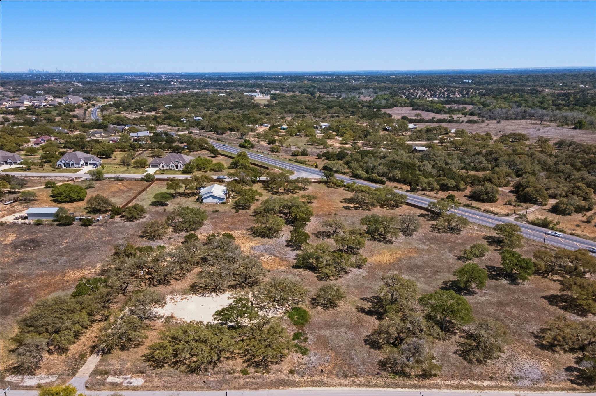268 Kinnikinik Loop Austin, TX 78737 - Photo 6 of 32 an aerial view of residential building and green space