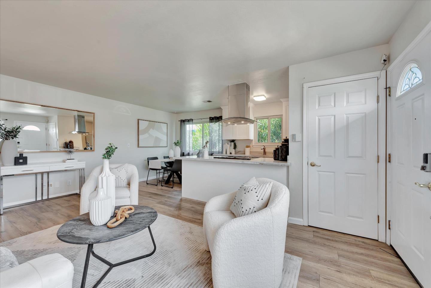 a living room with furniture a dining table and chairs
