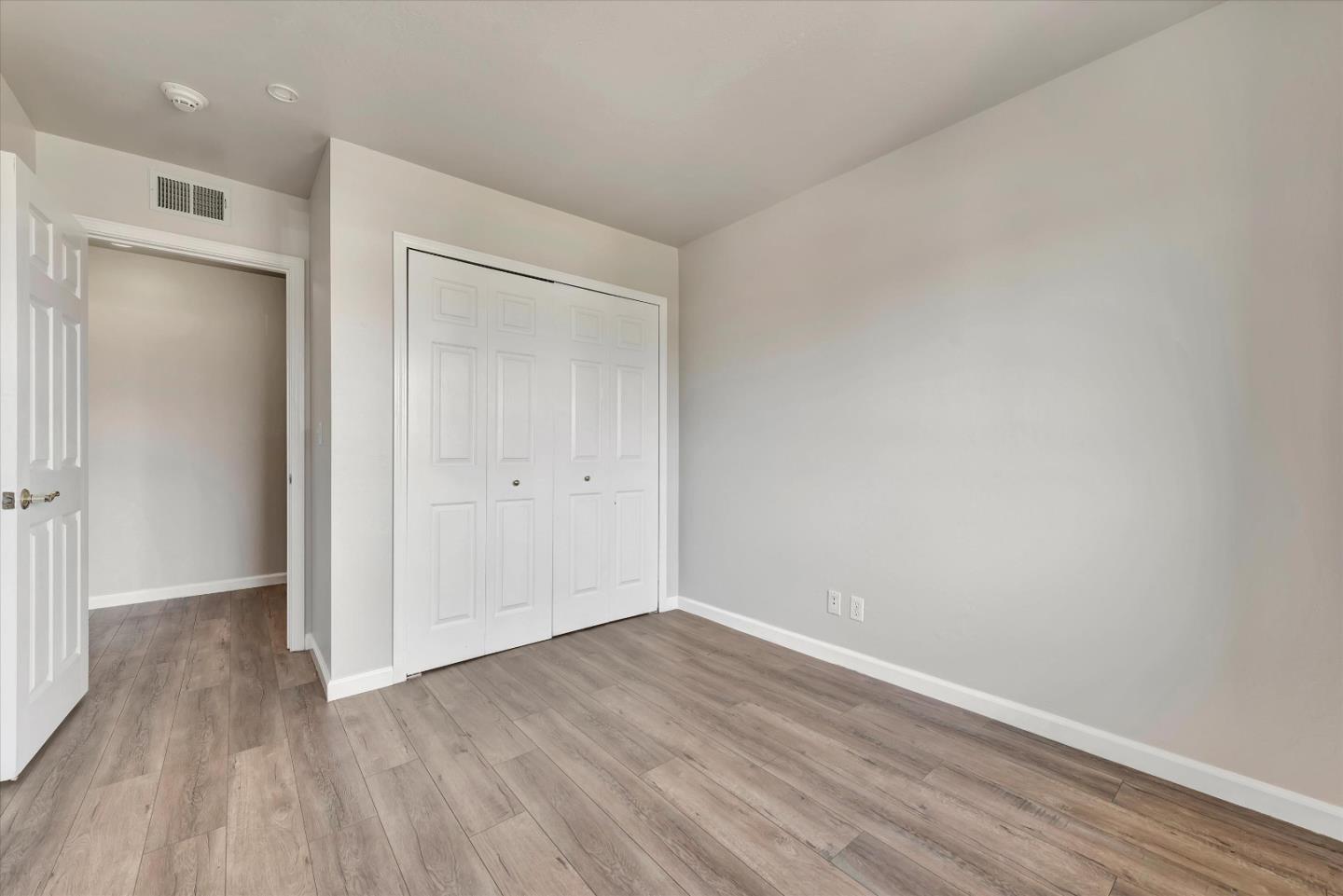 231 Watson Drive, Unit 4 Campbell, CA 95008 - Photo 13 of 16 a view of an empty room with wooden floor