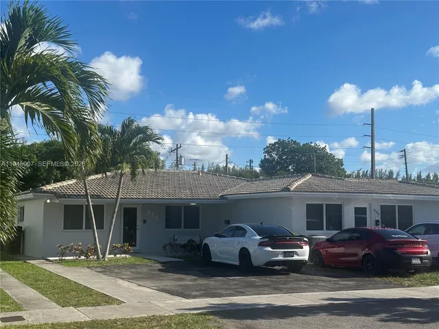 a front view of a house with a garden and patio