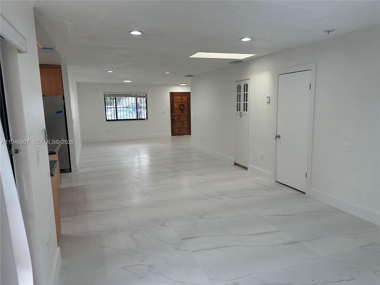 326 East 34th Street Hialeah, FL 33013 - Photo 11 of 26 an empty room with windows