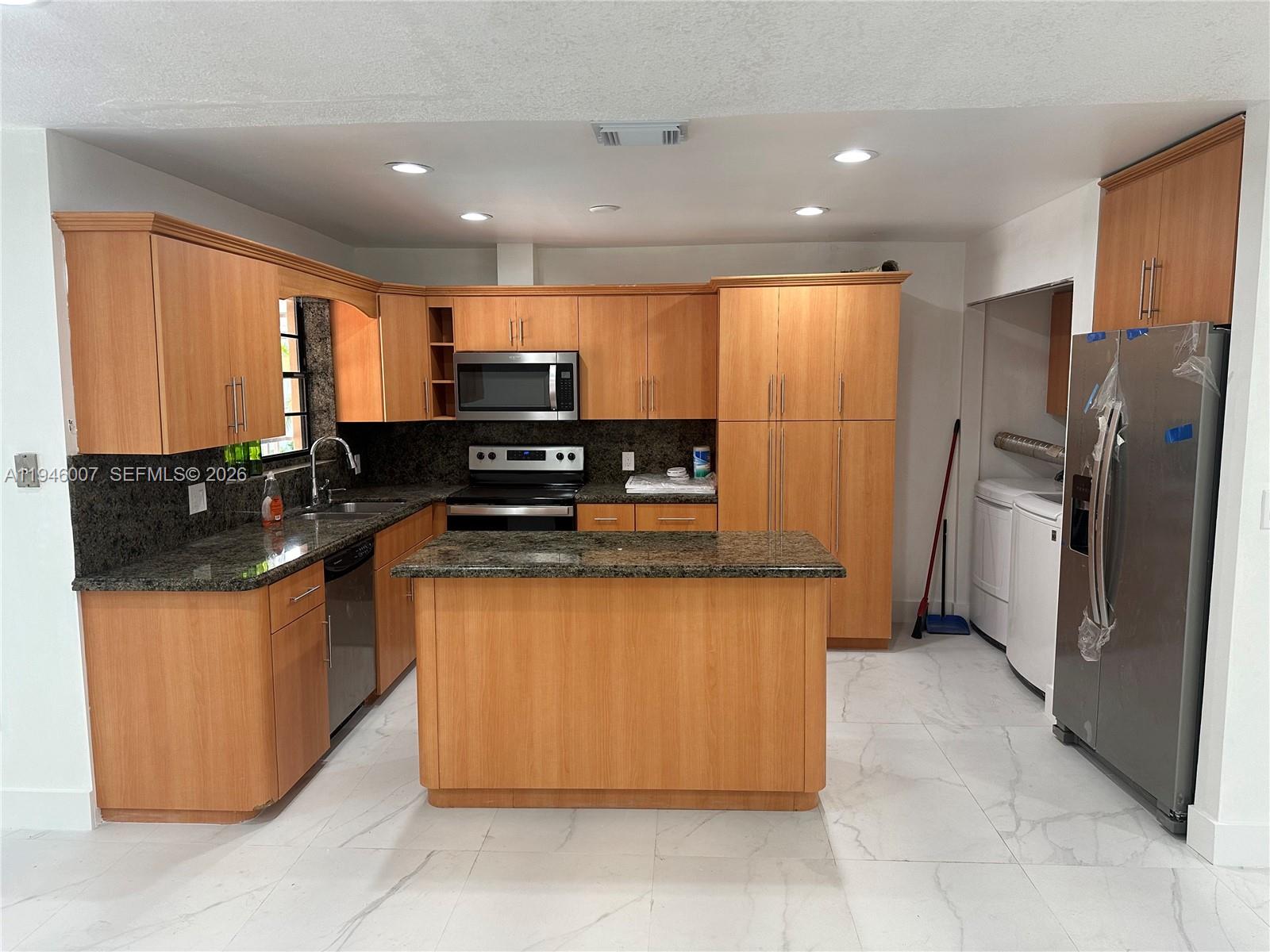 326 East 34th Street Hialeah, FL 33013 - Photo 12 of 26 a kitchen with stainless steel appliances granite countertop a refrigerator and a stove