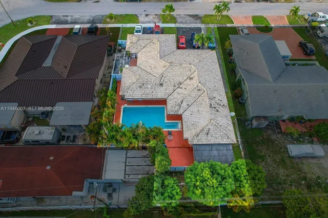 an aerial view of a house with a yard