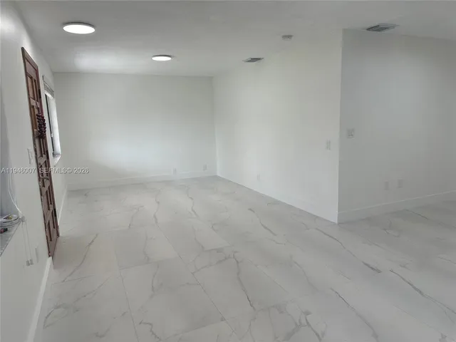 en empty room with wooden floor