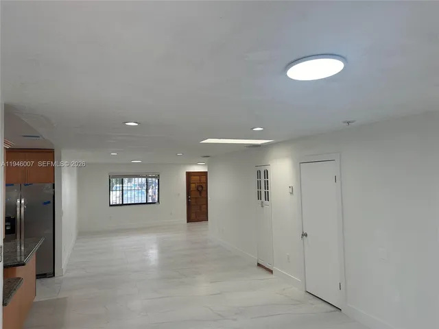 a view of an empty room and a window