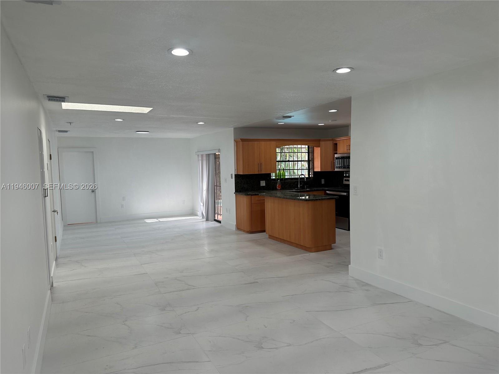 326 East 34th Street Hialeah, FL 33013 - Photo 10 of 26 a view of a kitchen with a sink and an empty room
