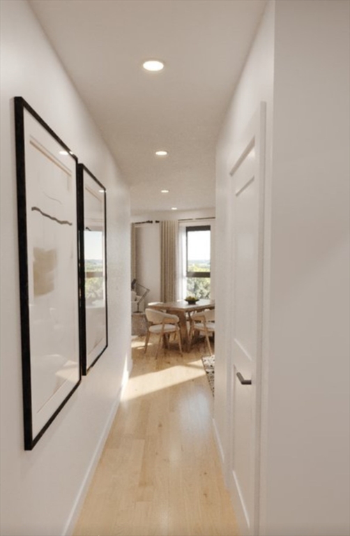 a view of a hallway with couch and a chandelier