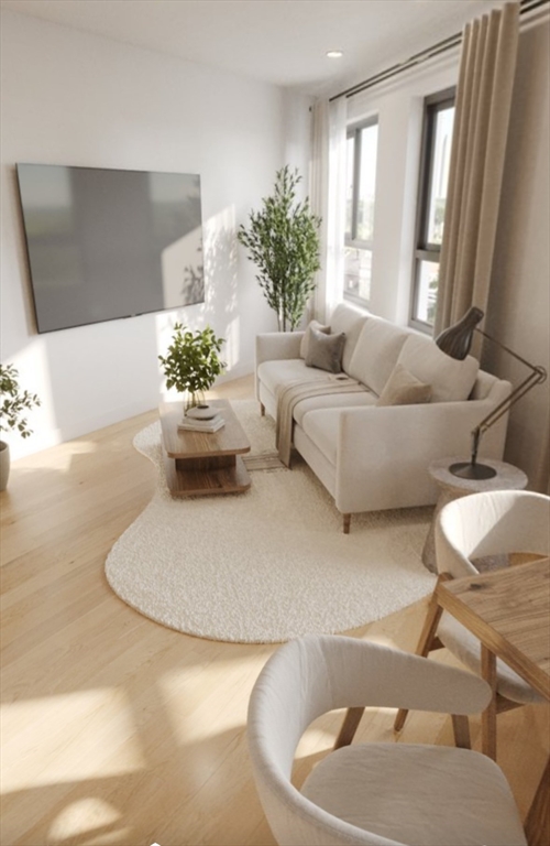 272 Talbot Avenue, Unit 203 Boston, MA 02124 - Photo 4 of 12 a living room with furniture and a potted plant