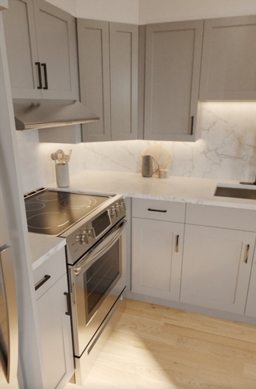 272 Talbot Avenue, Unit 203 Boston, MA 02124 - Photo 7 of 12 a kitchen with granite countertop white cabinets and a stove