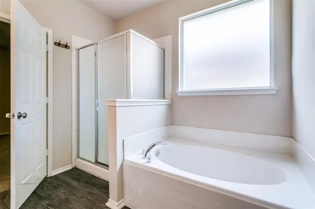 a white bath tub sitting next to a window