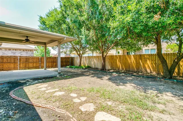 a view of backyard with large tree