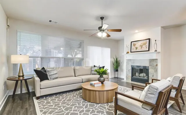 a living room with furniture and a fireplace