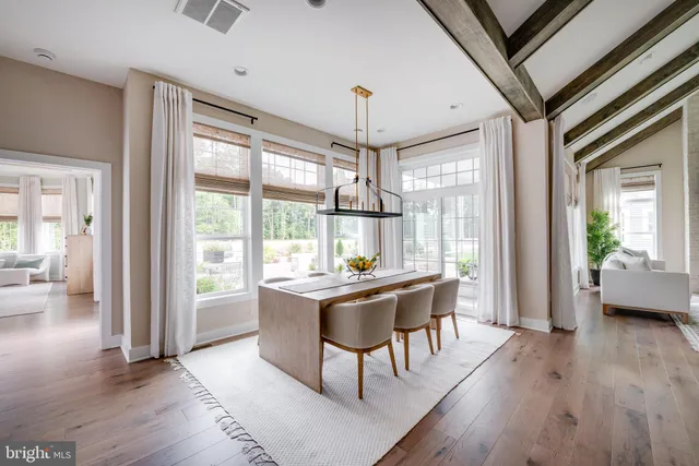 a dining room with wooden floor and furniture