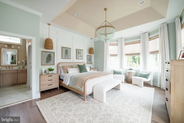 a spacious bedroom with a large bed and a chandelier