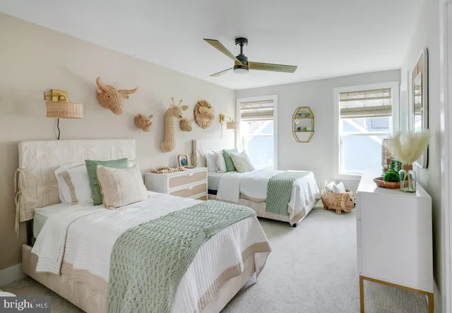 a bedroom with two beds and a window