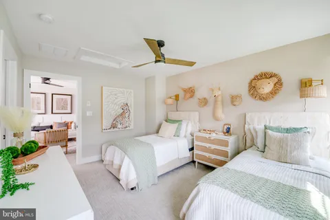 a bedroom with two beds and painting on the wall