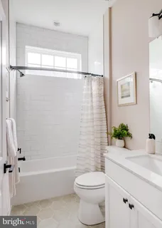 a bathroom with a sink a toilet a tub and shower