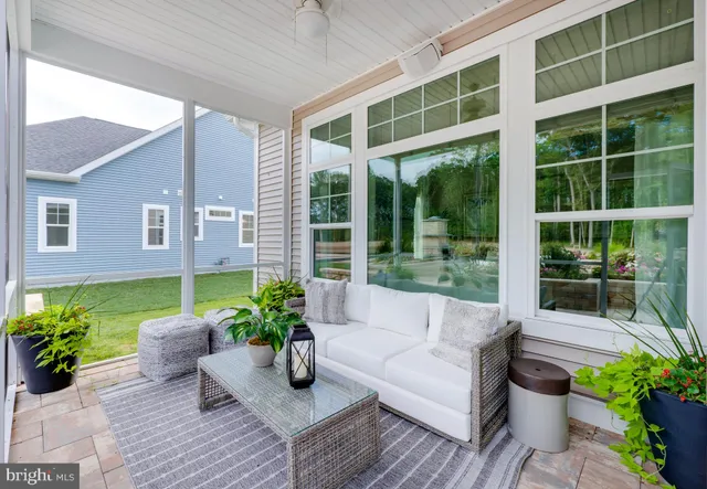 a view of a patio with couches and potted plants