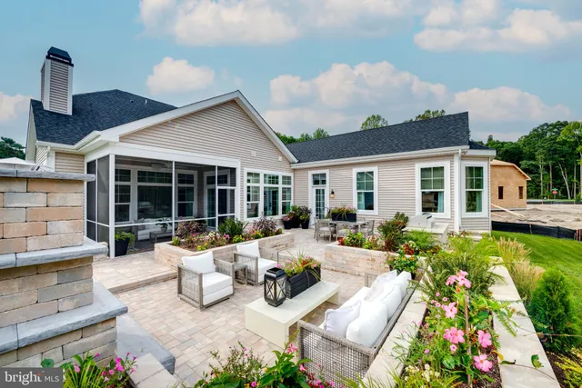 a view of a house with couches chairs and potted plants