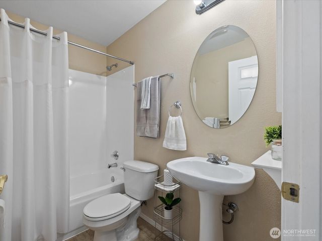 a bathroom with a sink toilet and a mirror