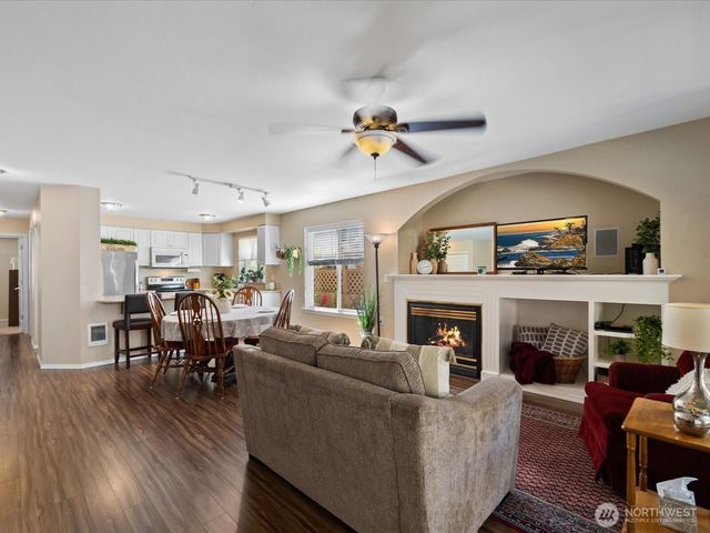 a living room with fireplace furniture and a wooden floor