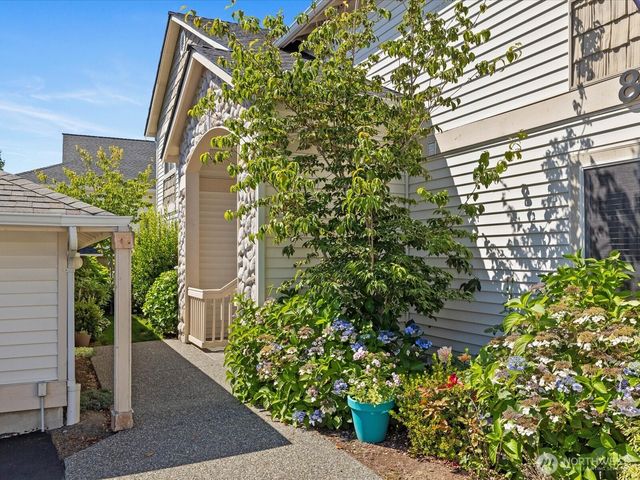 a view of a house with a flower garden