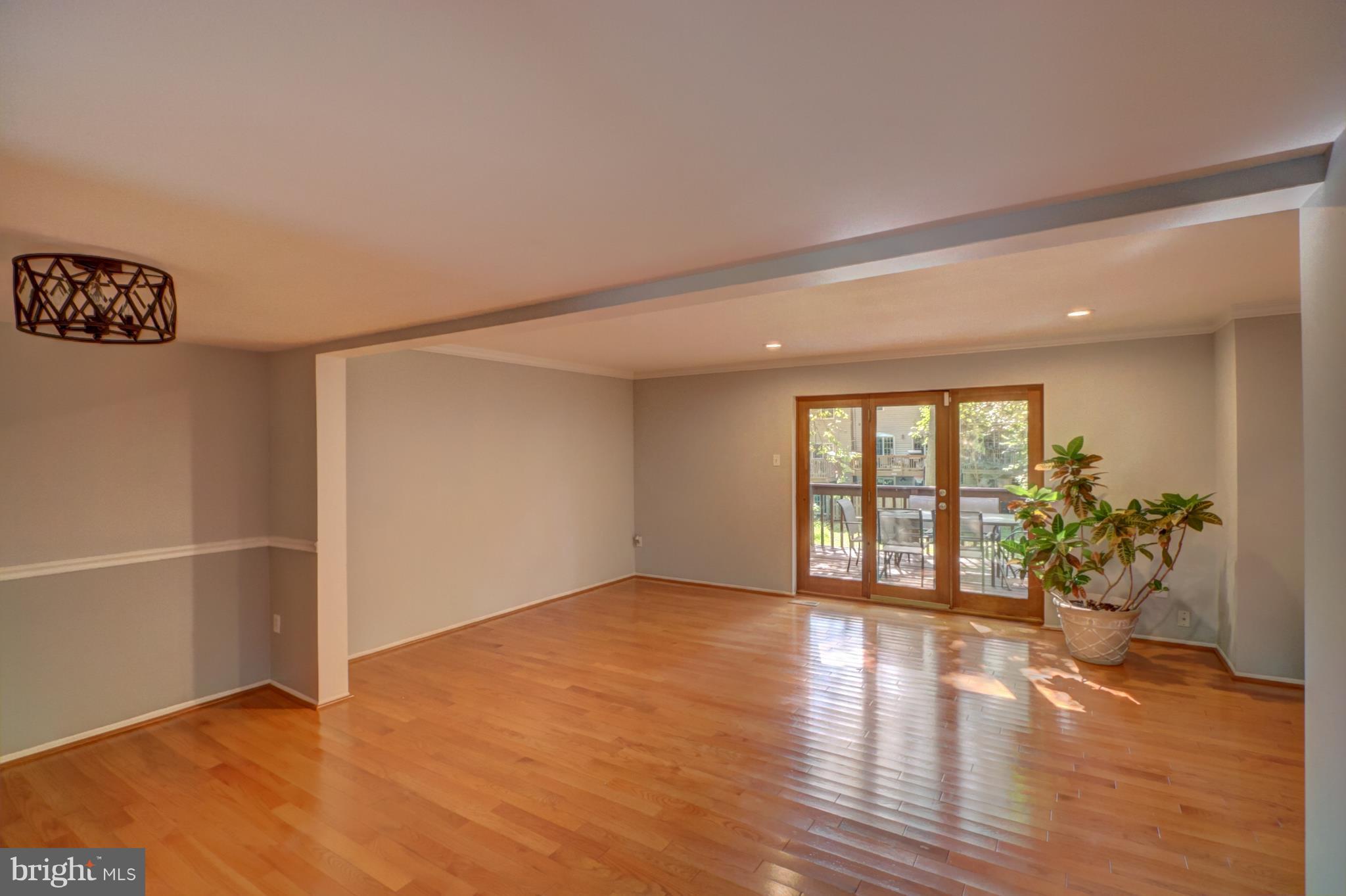 7068 Winter Rose Path Columbia, MD 21045 - Photo 1 of 30 an empty room with wooden floor and windows