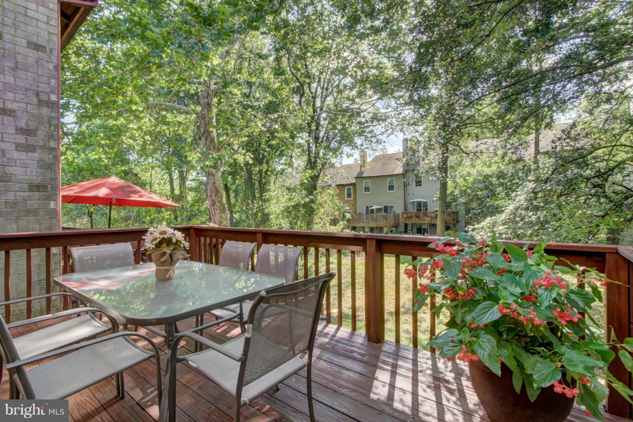 7068 Winter Rose Path Columbia, MD 21045 - Photo 12 of 30 a balcony with furniture and umbrella