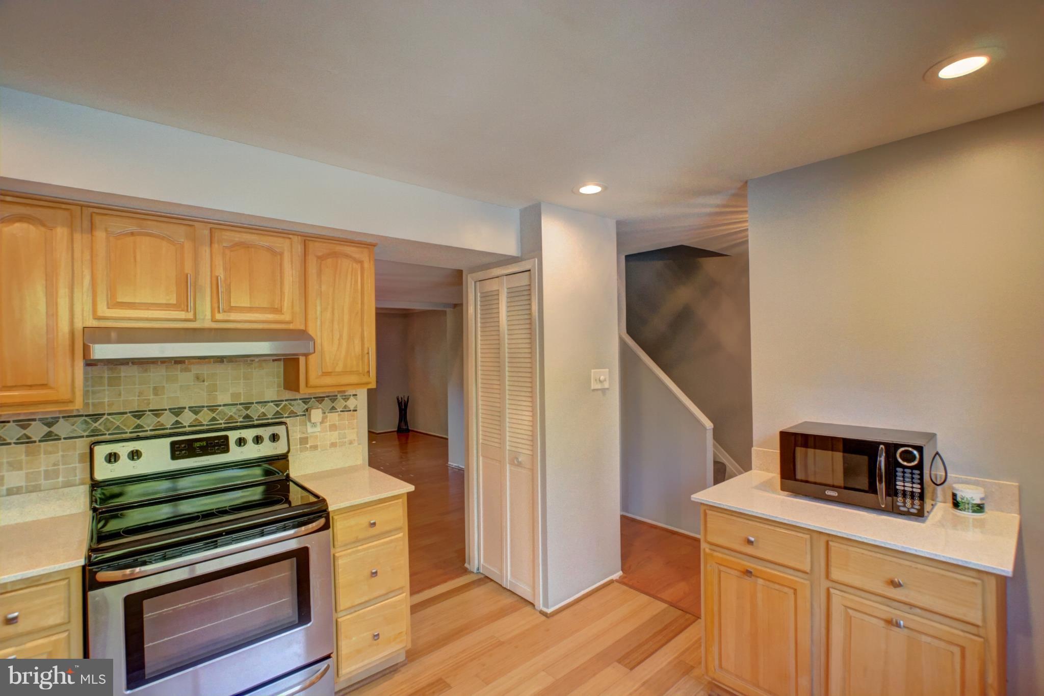 7068 Winter Rose Path Columbia, MD 21045 - Photo 3 of 30 a kitchen with a stove and a refrigerator