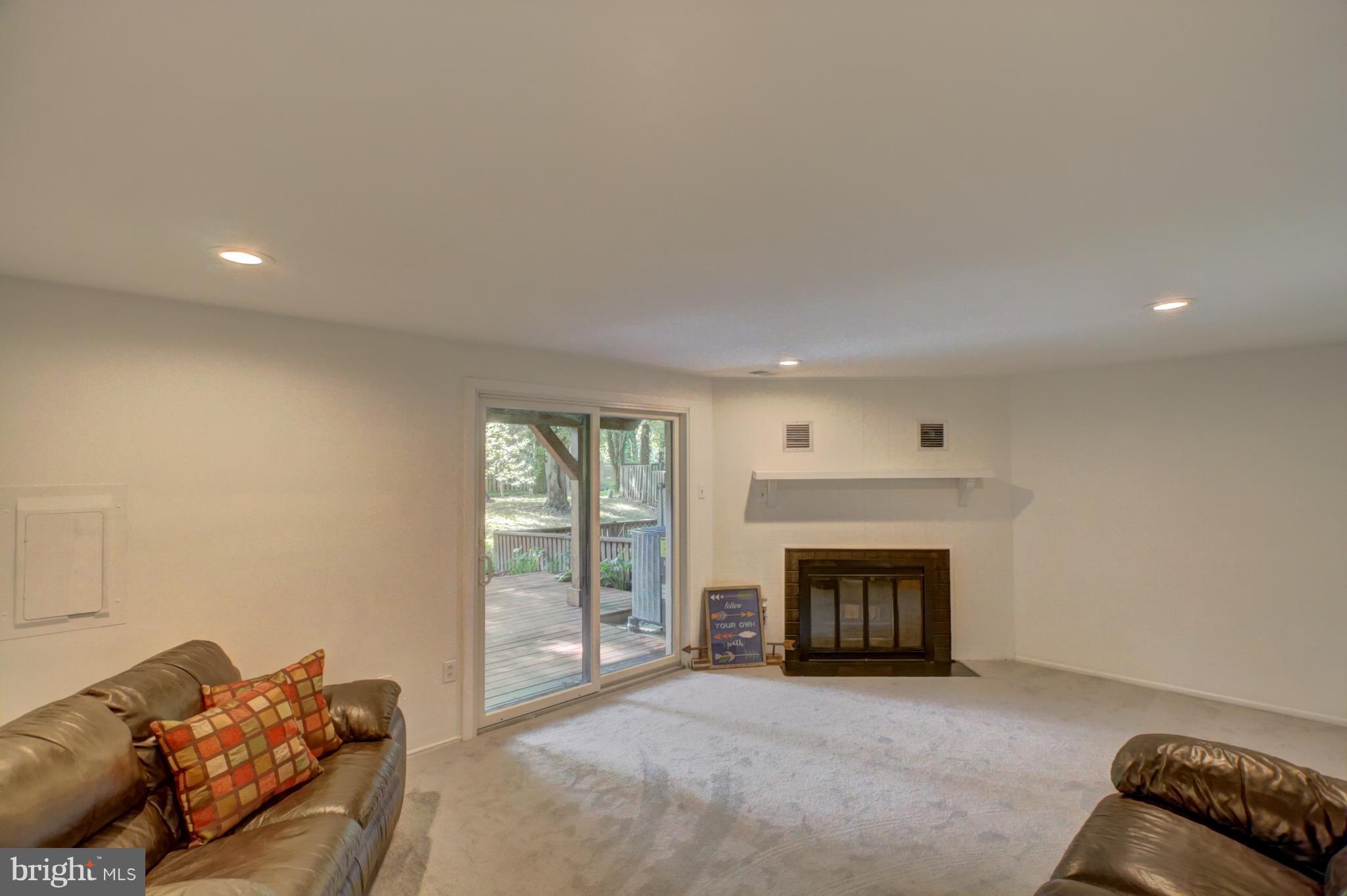 7068 Winter Rose Path Columbia, MD 21045 - Photo 23 of 30 a living room with furniture and a fireplace
